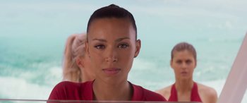 Movie still from “Baywatch” (2017), directed by Seth Gordon – A person wearing a red shirt; Close Up shot, Over the shoulder angle