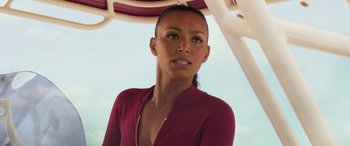 Movie still from “Baywatch” (2017), directed by Seth Gordon – A woman in a red shirt under an umbrella; Close Up shot, Low angle