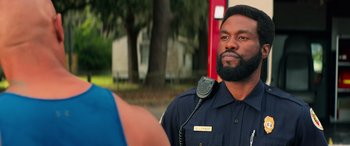 Movie still from “Baywatch” (2017), directed by Seth Gordon – A man in a police uniform is talking to a woman; Close Up shot, Over the shoulder angle