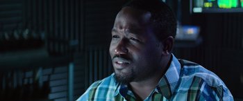 Movie still from “Baywatch” (2017), directed by Seth Gordon – A person wearing a plaid shirt; Close Up shot, High angle