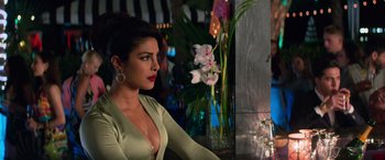 Movie still from “Baywatch” (2017), directed by Seth Gordon – A woman sitting in front of a vase of flowers; Close Up shot, Over the shoulder angle