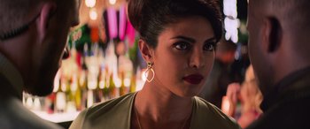 Movie still from “Baywatch” (2017), directed by Seth Gordon – A person wearing a necklace and earrings; Close Up shot, Over the shoulder angle