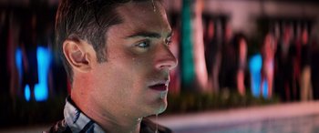 Movie still from “Baywatch” (2017), directed by Seth Gordon – A man's face with water droplets on his face; Close Up shot, Over the shoulder angle