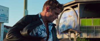 Movie still from “Baywatch” (2017), directed by Seth Gordon – A person wearing a shirt and jacket; Medium shot, Low angle
