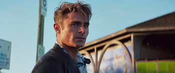 Movie still from “Baywatch” (2017), directed by Seth Gordon – A person wearing a jacket; Close Up shot, Low angle