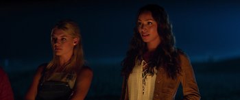 Movie still from “Baywatch” (2017), directed by Seth Gordon – Two women standing next to each other at night; Close Up shot, Low angle