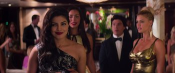 Movie still from “Baywatch” (2017), directed by Seth Gordon – Two women and a man in formal attire; Close Up shot, Over the shoulder angle