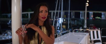 Movie still from “Baywatch” (2017), directed by Seth Gordon – A beautiful woman with long black hair standing on top of a boat at night; Close Up shot, Over the shoulder angle