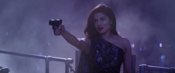 Movie still from “Baywatch” (2017), directed by Seth Gordon – A woman holding a gun in her right hand; Close Up shot, Over the shoulder angle