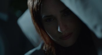 Movie still from “Beau Is Afraid” (2023), directed by Ari Aster – A woman's face with a hood over her head; Extreme Close Up shot, Low angle