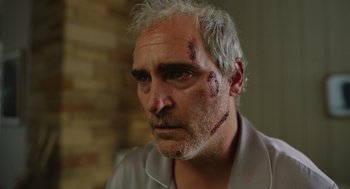 Movie still from “Beau Is Afraid” (2023), directed by Ari Aster – A person with makeup on his face; Close Up shot, Low angle