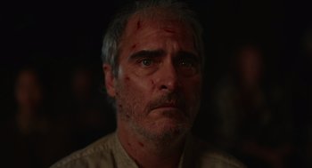 Movie still from “Beau Is Afraid” (2023), directed by Ari Aster – A person wearing a shirt; Close Up shot, Low angle