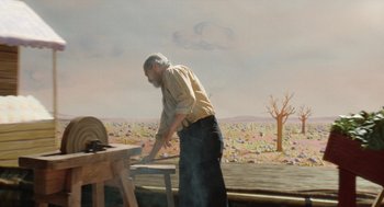 Movie still from “Beau Is Afraid” (2023), directed by Ari Aster – An old man standing in front of an outdoor grill; Wide shot, High angle