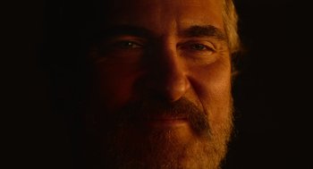 Movie still from “Beau Is Afraid” (2023), directed by Ari Aster – A man with a beard looking at the camera; Extreme Close Up shot, Low angle