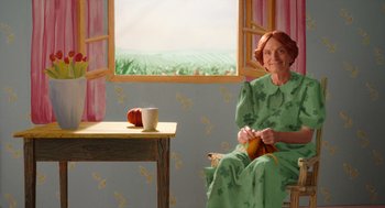 Movie still from “Beau Is Afraid” (2023), directed by Ari Aster – A painting of an older woman sitting in front of a window; Medium shot, High angle