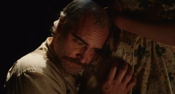 Movie still from “Beau Is Afraid” (2023), directed by Ari Aster – A person with a beard; Close Up shot, High angle