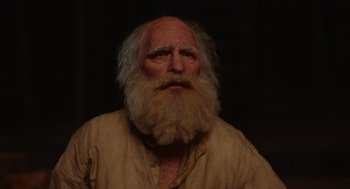 Movie still from “Beau Is Afraid” (2023), directed by Ari Aster – An old man with a long white beard; Close Up shot, Low angle