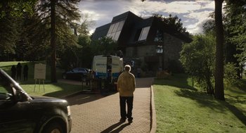 Movie still from “Beau Is Afraid” (2023), directed by Ari Aster – An older man standing in front of a truck; Extreme Wide shot, Low angle