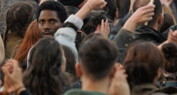 A group of people standing around each other in a crowd