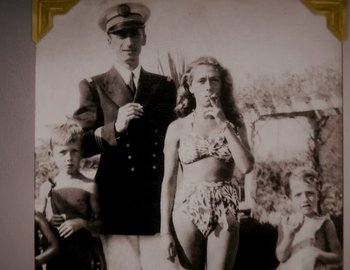 Movie still from “Becoming Cousteau” (2021), directed by Liz Garbus – An old photo of a man and a woman in bathing suits; Medium shot, Low angle