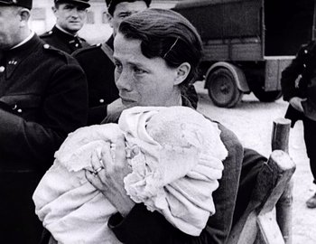 Movie still from “Becoming Cousteau” (2021), directed by Liz Garbus – A woman holding a bunch of towels in her arms; Close Up shot, High angle