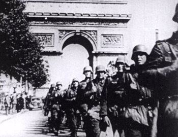 Movie still from “Becoming Cousteau” (2021), directed by Liz Garbus – A black and white photo of soldiers marching down a street; Wide shot, High angle