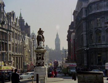 Movie still from “Becoming Cousteau” (2021), directed by Liz Garbus – A statue of a man on a horse on a city street; Extreme Wide shot, Low angle