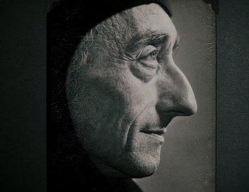 Movie still from “Becoming Cousteau” (2021), directed by Liz Garbus – An old man with a beard and a hat on his head; Extreme Close Up shot, Low angle
