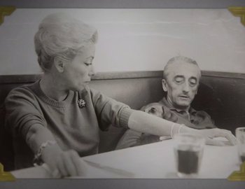 Movie still from “Becoming Cousteau” (2021), directed by Liz Garbus – An older man and woman sitting at a table; Close Up shot, High angle