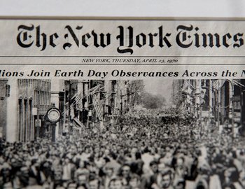 Movie still from “Becoming Cousteau” (2021), directed by Liz Garbus – A black and white photo of a newspaper with the new york times on it; Extreme Close Up shot, High angle