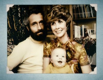 Movie still from “Becoming Cousteau” (2021), directed by Liz Garbus – An old photo of a man , woman , and a baby; Extreme Close Up shot, Overhead angle