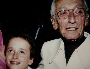 Movie still from “Becoming Cousteau” (2021), directed by Liz Garbus – An older man and a young boy smiling for the camera; Close Up shot, High angle