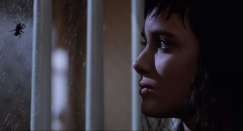 Movie still from “Beetlejuice” (1988), directed by Tim Burton – A person looking out of a window; Close Up shot, Low angle