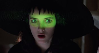 Movie still from “Beetlejuice” (1988), directed by Tim Burton – A woman with green light on her head and face; Close Up shot, Low angle