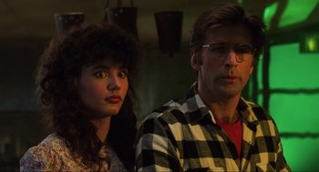 Movie still from “Beetlejuice” (1988), directed by Tim Burton – A man and a woman standing next to each other; Close Up shot, Low angle