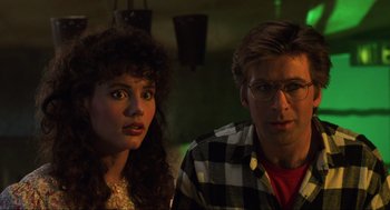 Movie still from “Beetlejuice” (1988), directed by Tim Burton – A man and a woman sitting next to each other; Close Up shot, Low angle