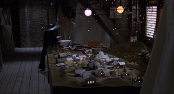 Movie still from “Beetlejuice” (1988), directed by Tim Burton – A model of a town in a room with lights; Extreme Wide shot, High angle
