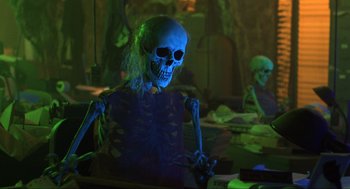 Movie still from “Beetlejuice” (1988), directed by Tim Burton – A skeleton is standing in front of a bunch of other skeletons; Medium shot, Low angle