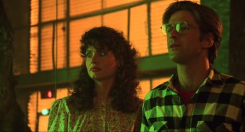 Movie still from “Beetlejuice” (1988), directed by Tim Burton – A man and a woman standing next to each other in front of a window; Close Up shot, Low angle