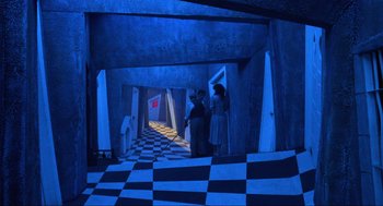 Movie still from “Beetlejuice” (1988), directed by Tim Burton – Two people are standing in a room with checkerboard floors; Extreme Wide shot, High angle