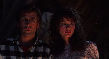 Movie still from “Beetlejuice” (1988), directed by Tim Burton – A man and a woman sitting next to each other; Close Up shot, Low angle