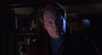 Movie still from “Beetlejuice” (1988), directed by Tim Burton – A person wearing a jacket; Close Up shot, Low angle