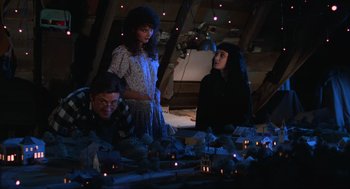 Movie still from “Beetlejuice” (1988), directed by Tim Burton – A group of people standing next to each other in a room; Medium shot, High angle