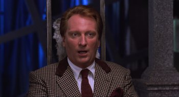 Movie still from “Beetlejuice” (1988), directed by Tim Burton – A person wearing a suit and tie; Close Up shot, Over the shoulder angle