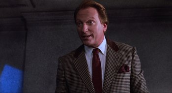 Movie still from “Beetlejuice” (1988), directed by Tim Burton – A person wearing a suit and a tie; Close Up shot, Low angle