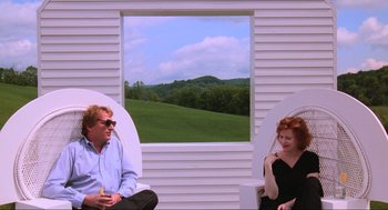 Movie still from “Beetlejuice” (1988), directed by Tim Burton – A man and a woman sitting in front of an open window; Medium shot, Over the shoulder angle