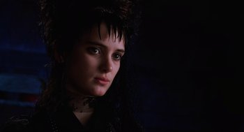 Movie still from “Beetlejuice” (1988), directed by Tim Burton – A young woman with dark hair wearing a black dress; Close Up shot, Low angle