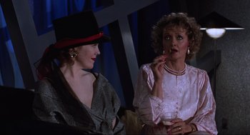 Movie still from “Beetlejuice” (1988), directed by Tim Burton – Two women are sitting and talking to each other; Medium shot, Over the shoulder angle