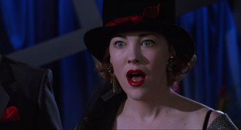 Movie still from “Beetlejuice” (1988), directed by Tim Burton – A person wearing a top hat; Close Up shot, Over the shoulder angle