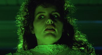 Movie still from “Beetlejuice” (1988), directed by Tim Burton – A woman's face in green light; Close Up shot, Low angle